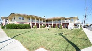 A two-story motel with a central courtyard, balconies, and a parking area. - Virginian 4-Oceanside 11th St, Free WiFi, W/D, AC (Ocean City)
