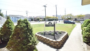 A sign for the Virginian Condominium 1101, surrounded by a landscaped area with trees and a paved path. - Virginian 4-Oceanside 11th St, Free WiFi, W/D, AC (Ocean City)