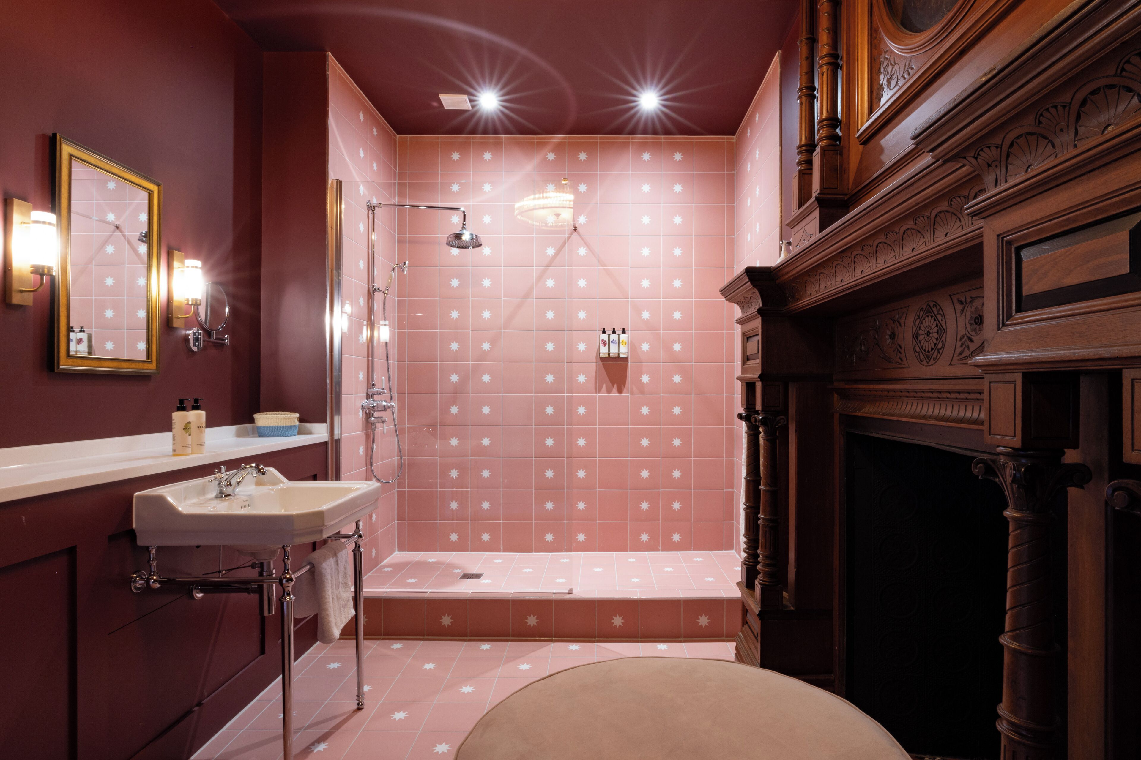 A bathroom with a sink, mirror, and shower.