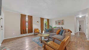 A spacious living room with a sofa, armchairs, a coffee table, and a rug. - Bright & Bold Retreat in Tulsa, OK (Tulsa)