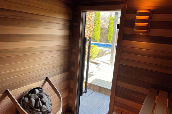 Cedar sauna with view of pool