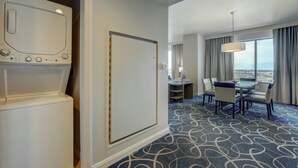 A hotel room with a large window, a dining area with a table and chairs, and a washing machine. - 2Bed/2Bath Deluxe in Las Vegas! (Las Vegas)