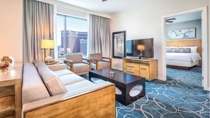 A hotel room with a sofa, TV, and a bed. - 2Bed/2Bath Deluxe in Las Vegas! (Las Vegas)