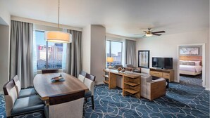 A hotel room with a dining area, a TV, a bed, and a city view. - 2Bed/2Bath Deluxe in Las Vegas! (Las Vegas)