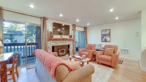 A spacious living room with a fireplace, a sofa, a chair, and a dining area with a table and chairs. - Ski Condo w/ Community Amenities in Mammoth Lakes! (Mammoth Lakes)