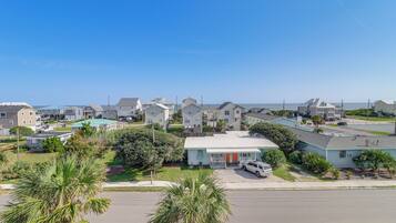 A residential neighborhood with houses, a street, and a clear blue sky.