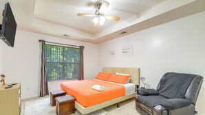 A bedroom with a bed, a chair, a desk, and a window with curtains. - Home w/ Dog-friendly Yard in Quiet Atlanta Suburb (Hampton)