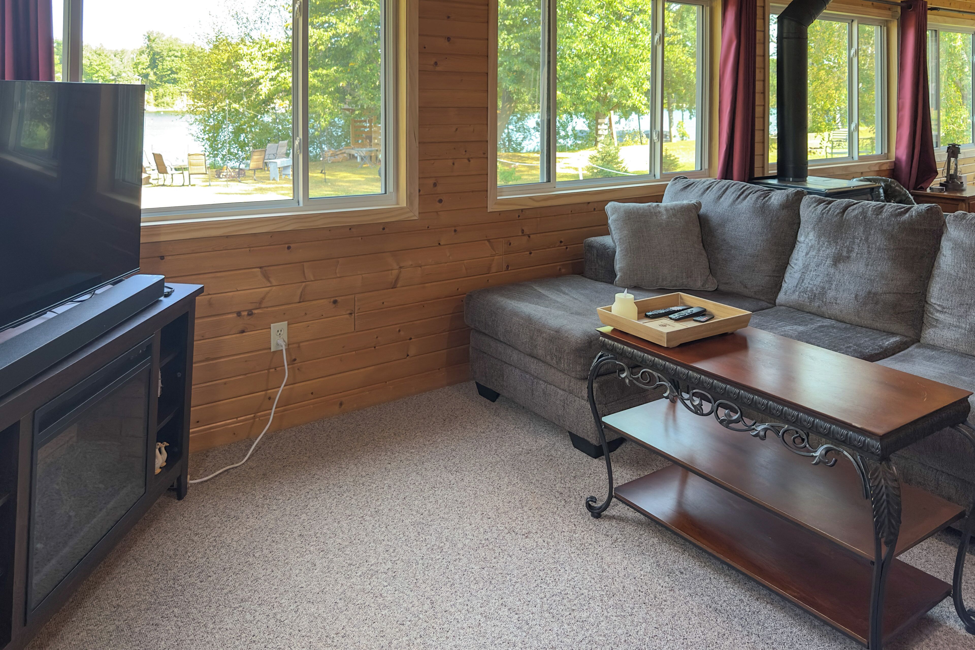A living room with a television, sofa, and coffee table.