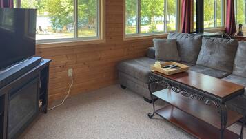 A living room with a television, sofa, and coffee table.