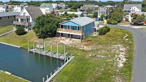 A residential area with a house featuring a dock and a small pool.