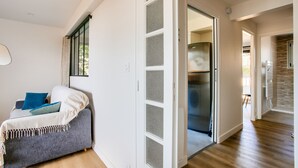 A modern living room with a grey sofa, a white wall, and a wooden floor. - 130m from the beach, nice flat for 4 (Pléneuf-Val-André)
