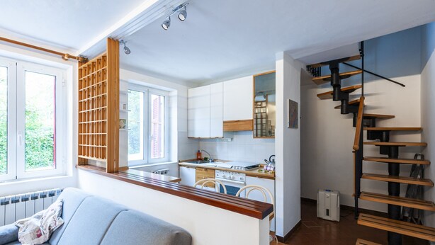 A modern kitchen with white cabinets, a wooden countertop, and a built-in stove. - Ca da Lalla by Wonderful Italy (Varazze)