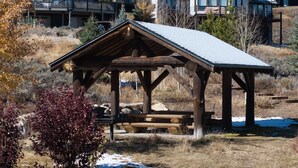 A rustic wooden pavilion with a sloped roof, situated in a natural setting with dry grass and a few trees. - Scenic Perch 2 Bedroom Home (Tabernash)