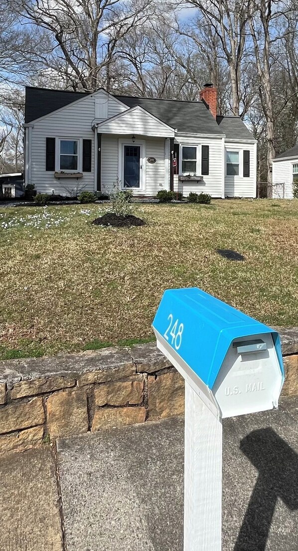 A mailbox with the number 248, located in front of a house with a stone wall and a grassy yard. - Entire home, charming 3-2 near the Marietta square! (Marietta)
