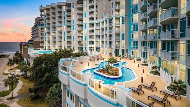 A multi-story hotel with a pool area, balconies, and a view of the ocean. - ⛱️Ocean View Retreat with Private Balcony | Horizon at 77th - Unit 206🌊 (Myrtle Beach)