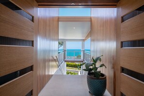 A modern interior with a view of the ocean. - The Lighthouse (Airlie Beach)