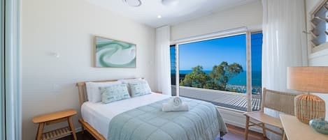 Rest easy in the second bedroom with a king bed and ocean views.