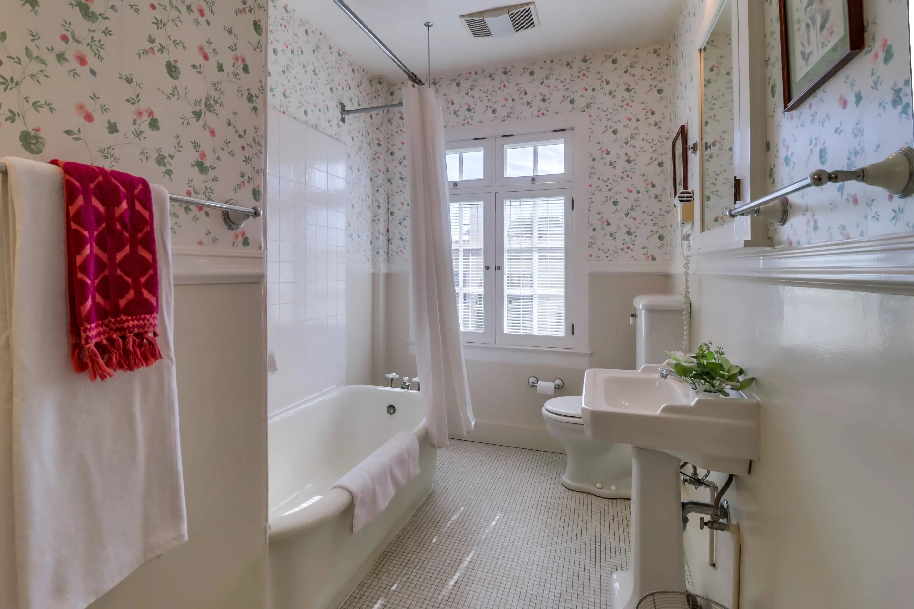 A bathroom with a bathtub, toilet, and sink.