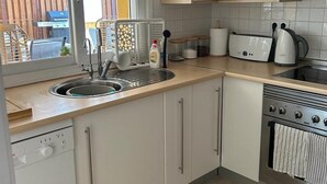A kitchen with a sink, stove, and toaster. - Baron Villa With Private Heated Pool on Mar Menor (Torre-Pacheco)