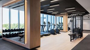 A modern gym with treadmills, dumbbells, and weight machines. - Park Inn By Radisson Hotel & Apartments Kuwait (Mahboula)