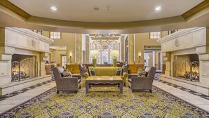 A spacious lobby with a central seating area, ornate chandeliers, and a patterned carpet. - Private Residence 3 in Park City (Park City)