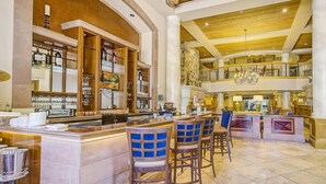 A spacious lobby with a high ceiling, a central bar area with stools, and a staircase leading to an upper level. - Private Residence 3 in Park City (Park City)