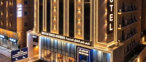 A hotel with a modern facade, multiple floors, and a prominent reception area.