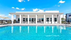 A modern building with a pool, white exterior, and large windows. - 5BR Villa w/ Pvt Pool, 15 Min to Disney, Sleeps 10 (Davenport)