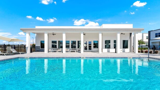 A modern building with a pool, white exterior, and large windows. - Modern 5BR Villa w/ Pool Near Disney (Davenport)