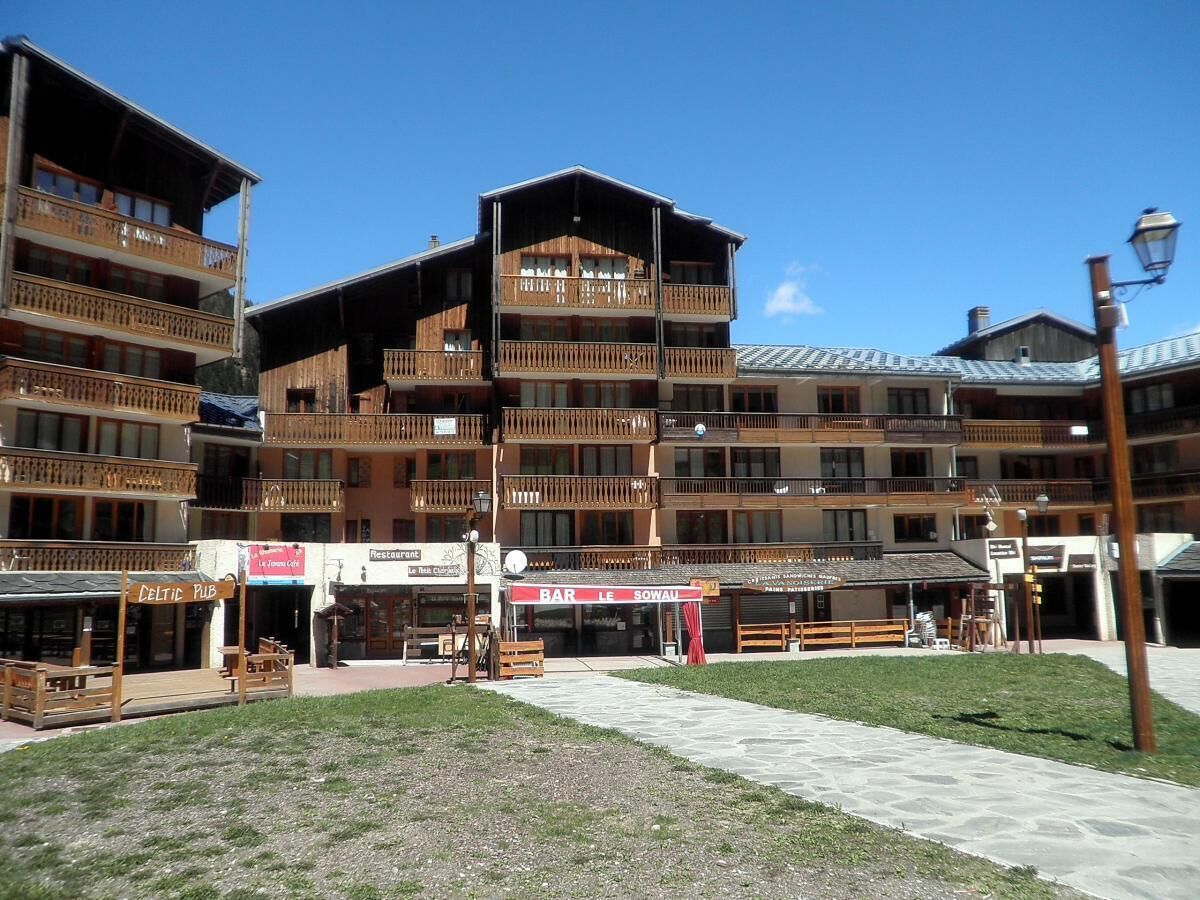 A multi-story building with balconies, a pub named "Celtic Pub," and a restaurant named "Le Resto."