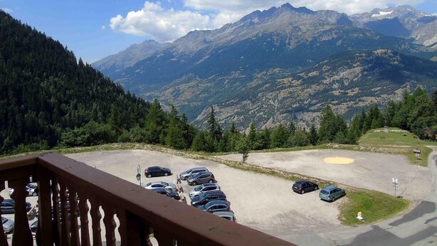A parking area with cars and a mountain view. - 5th floor, view mountain, balcony, tv, ski locker, 34m², Valfréjus (Valfréjus)