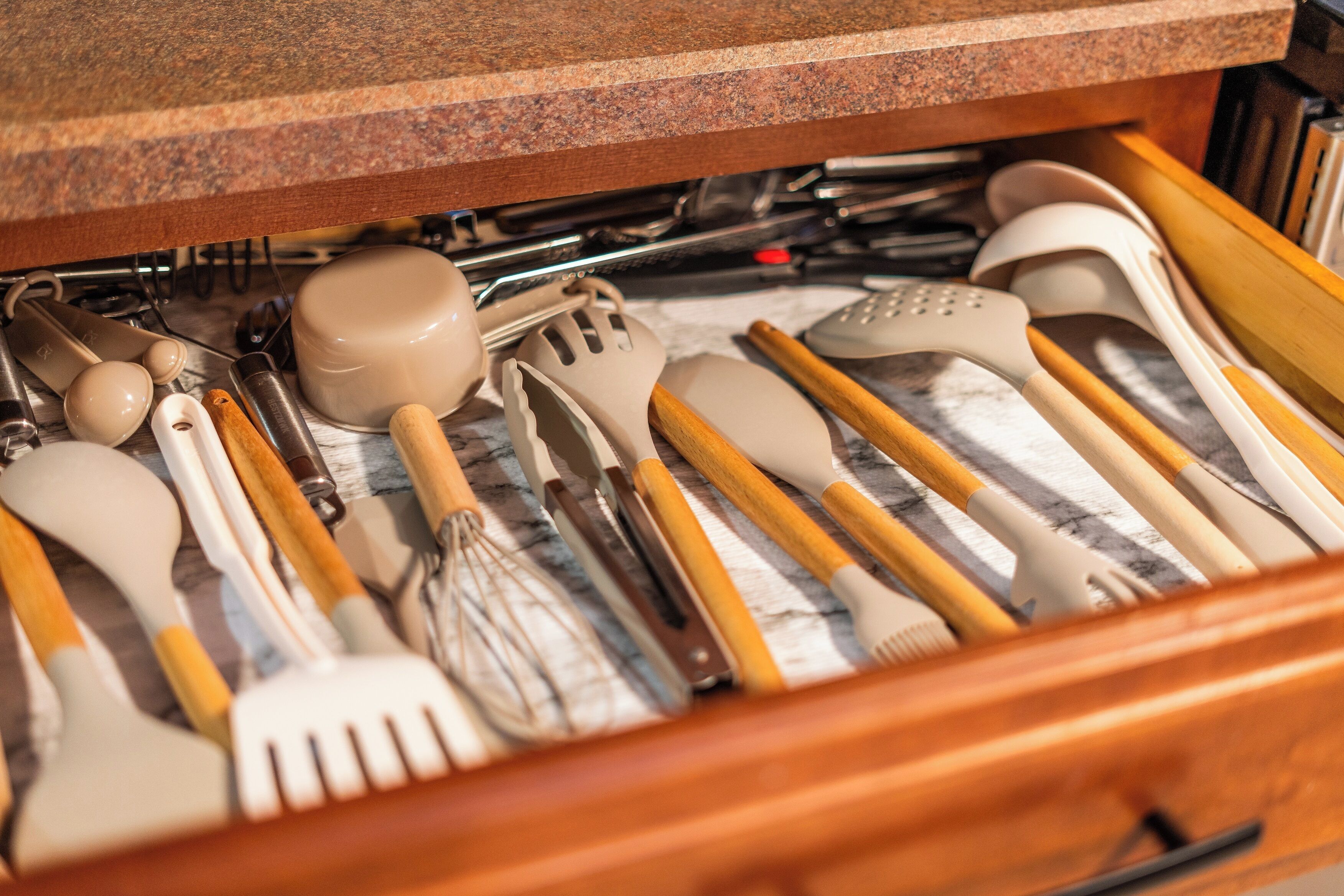A drawer filled with various kitchen utensils.