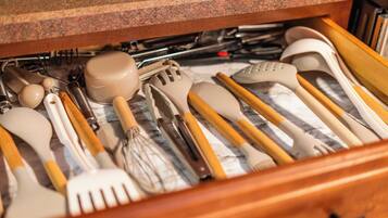 A drawer filled with various kitchen utensils.