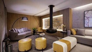 A modern living room with a sofa, ottoman, and a coffee table. - Get a Flat 1905 - Brooklin (São Paulo)
