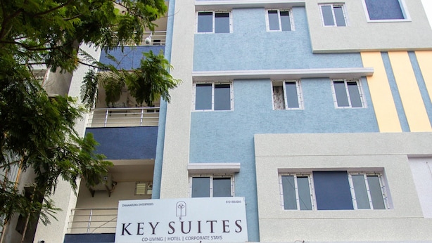 A multi-story building with a sign reading "Key Suites" indicating a hotel or corporate complex.