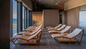 Relax in a serene spa area with comfortable loungers and a scenic view.
