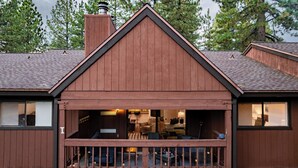A wooden house with a gabled roof, a visible chimney, and a porch with outdoor seating. - Walk to Lake, Dining+shops 5mins to Ski Resort Incline Paradise by Avantstay (Incline Village)