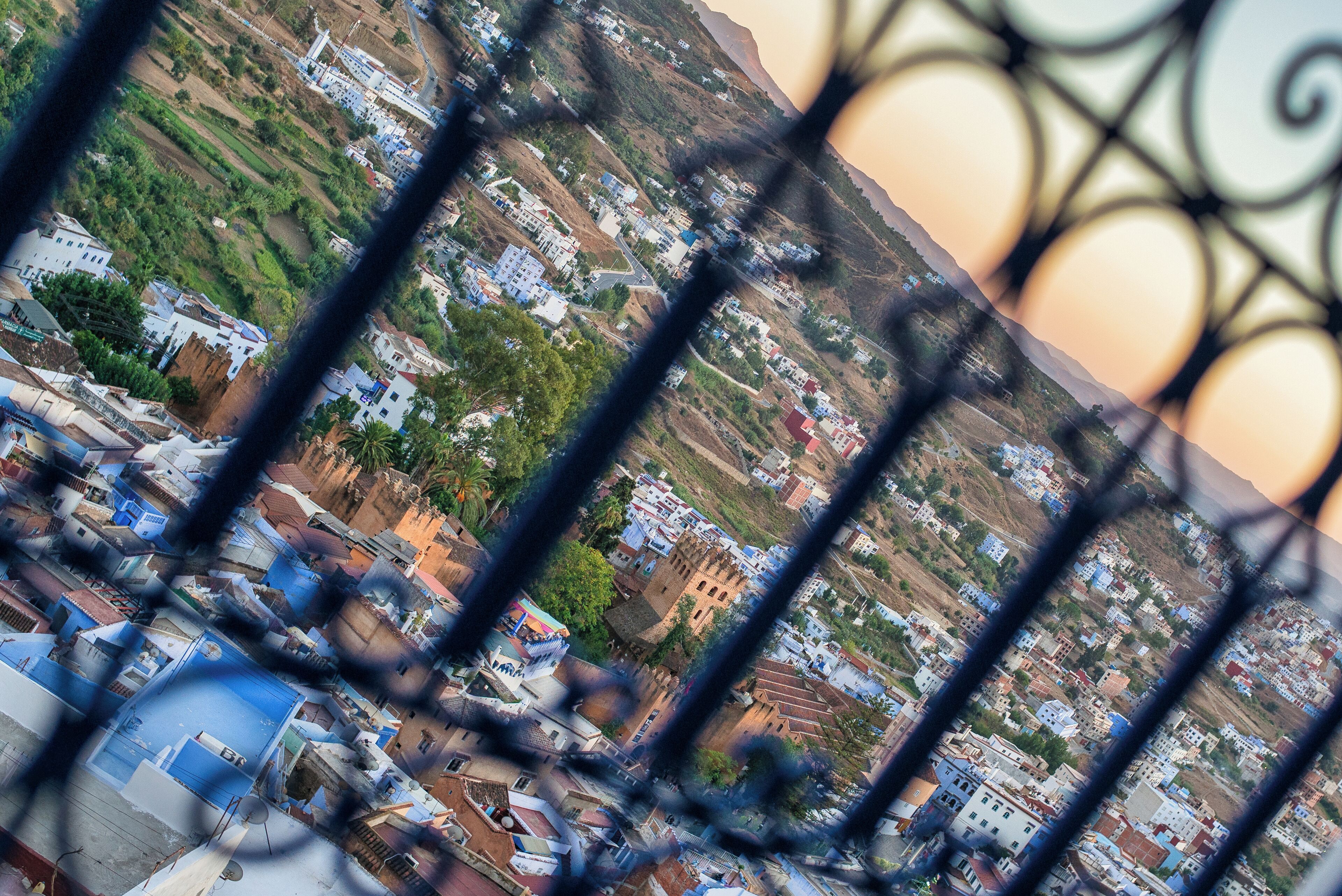 A view of a town with buildings and a mountain in the background.