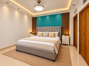 A modern bedroom with a bed, bedside tables, and a ceiling light fixture. - Charming 2-bedroom apartment on the Beach! (Guayacanes)