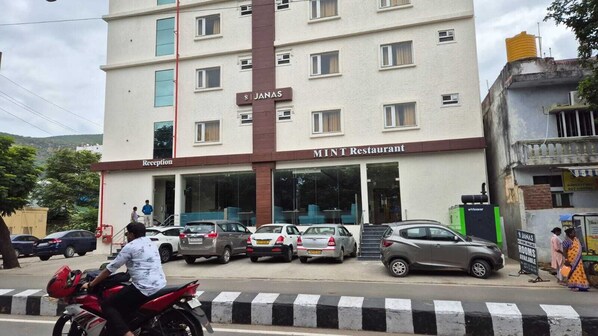 A multi-story building with a reception area and a restaurant named 'MINT Restaurant'. - Hotel Janas (Tirupati)