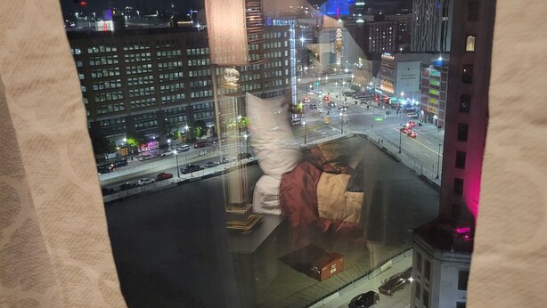 A nighttime cityscape view from a window, including a river, buildings, and a busy street. - Luxury 1 bedroom, 1 Bath apt. in the middle of downtown Detroit w/parking spot!  (Detroit)