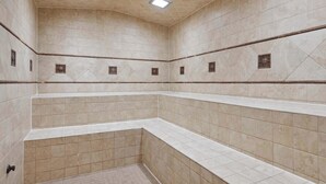 A tiled bathroom with a corner shower, a visible faucet, and a ceiling light fixture. - Ascent 108 - 2 Bedroom Residence (Avon)