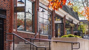 A brick building with a sign reading 'Haven's' and a staircase leading to the entrance. - Luxury Music Row Condo | King Bed & Balcony (Nashville)