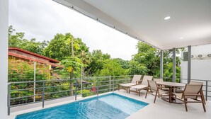 A rooftop pool area with a view of lush greenery and a red-roofed building in the background. - Los Mangos #3 • NEW! 3 BR Town-home • Private Plunge Pool Terrace, Coco Beach • Guests (Playa Hermosa)