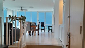 A staircase leading to a dining area with a view of the sky. - Two Bedroom Penthouse with Large Balcony overlooking the Ocean spectacularview (Fort Lauderdale)