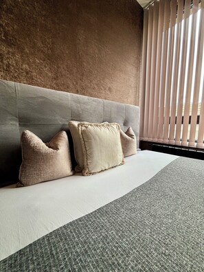 Relax in comfort on a plush bed with a stylish bedding set and enjoy the view from the large window.