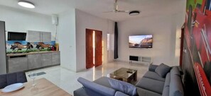 Relax in this stylish living space with a sofa, coffee table, and kitchenette.