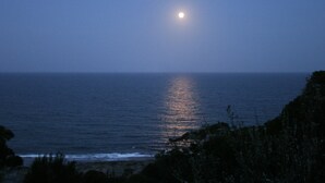 A night view of the ocean with a visible moon reflection on the water. - Welcoming 2-bedroom apartment in The Entrance (The Entrance)
