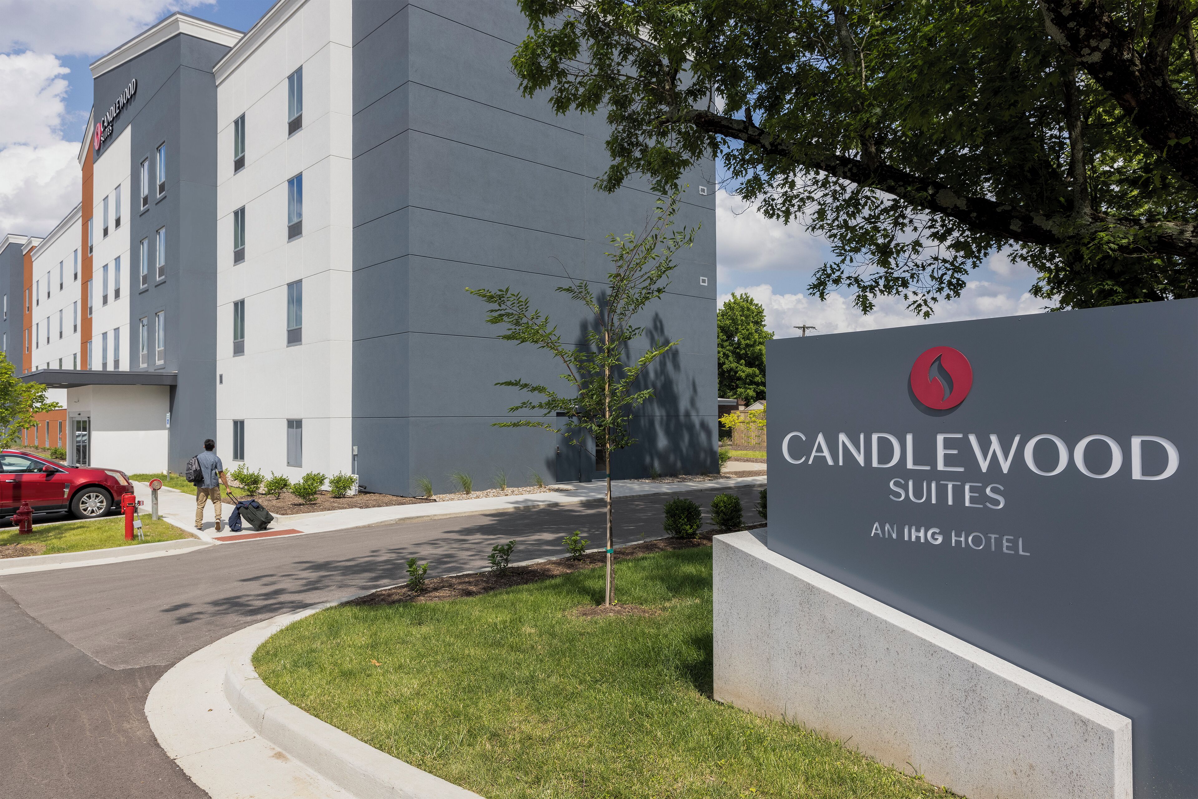 A modern hotel entrance with a sign for Candlewood Suites at an IHG Hotel.
