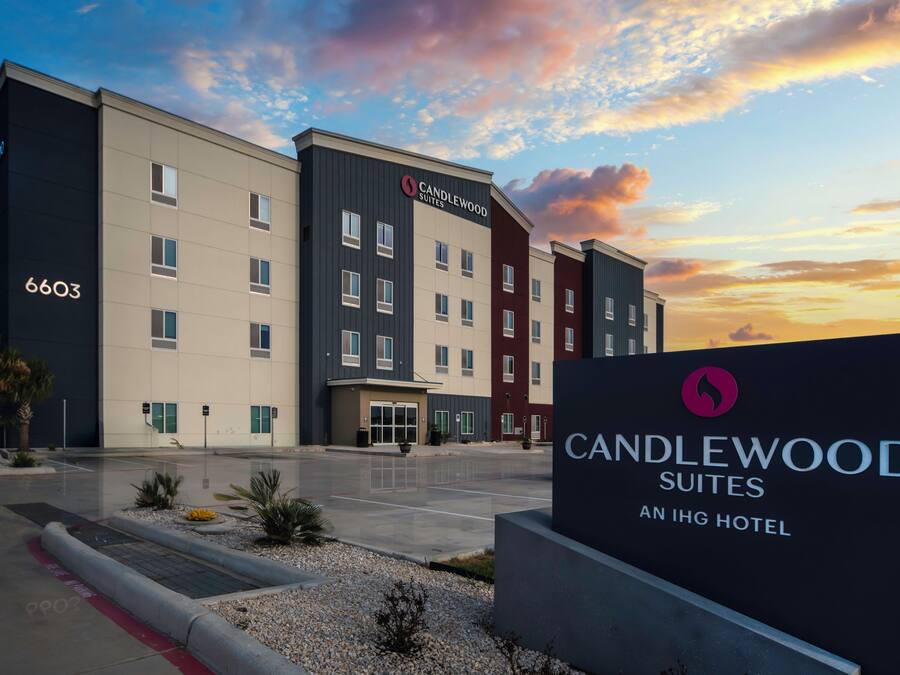 A hotel with a modern design, featuring multiple floors and a prominent entrance.